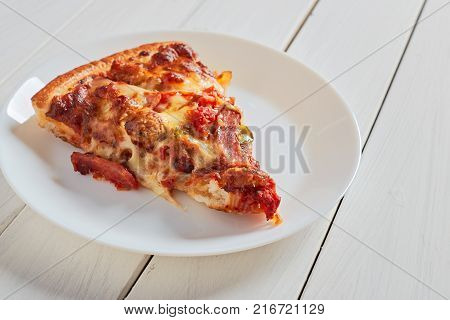 Top view of Italian rustic one slice pizza on white wooden table background concept flat lay food