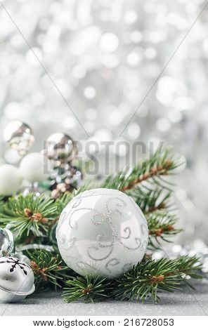 Silver Christmas background of defocused bokeh lights with decorated fir tree branches