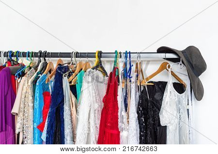 Many ladies evening gown long dresses on hanger in the dress rent shop for photo session. Dresses rental concept. Selective focus. Ball gown rental concept
