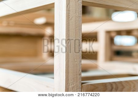 Close up image of newly made wooden beams attached to each other in carpenter's workshop