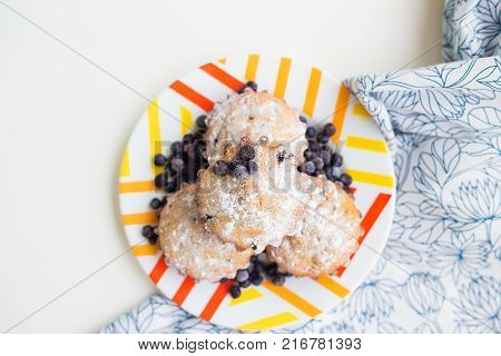 Blueberry muffins on plate and bright floral cloth