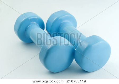 pair of light blue dumbbells for fitness isolated