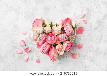 A beautiful heart made of macaroons and roses. Valentines day consept. flat lay, top view
