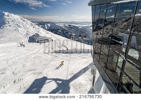 Cold snowy winter in Low Tatras mountains. Hill Chopok cottage Kamienka and cablewy at background Slovakia
