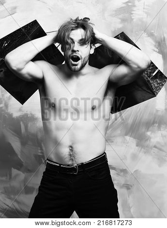 Caucasian Bearded Sexy Macho Man Holding Red Packages Or Bags