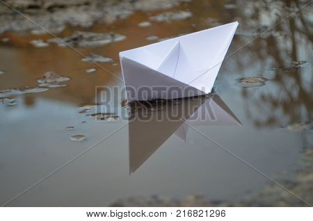 paper ship ship. paper boat sailing on water with waves and ripples