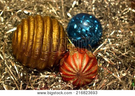 Colorful balloons and new year's toys lie on the garlands of foil.