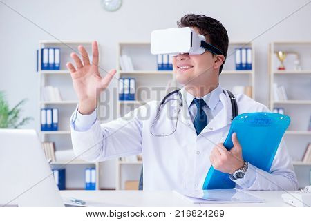 Young doctor with vr virtual reality headset working in the offi