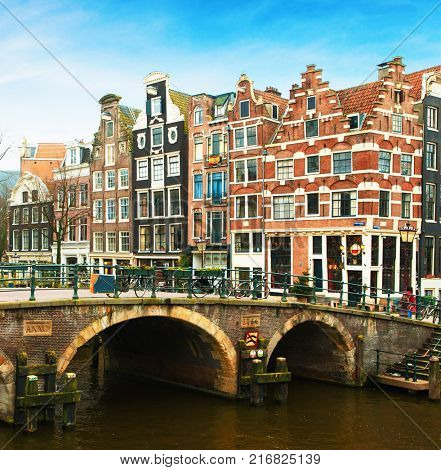 Prinsengracht canal  and  typical Dutch  houses behind the bridge in winter, Amsterdam, The Netherlands. 
  