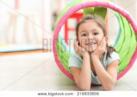 Cute little girl playing in kindergarten