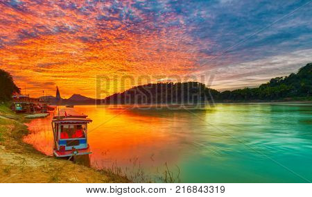 Touristic boat at sunset time. Beautiful landscape. Luang Prabang. Laos.