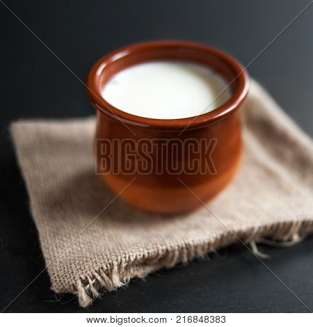 Homemade curd in clay pot made from cow milk. Sour cream or natural Cottage cheese