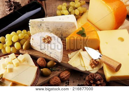 various types of cheese on rustic wooden table
