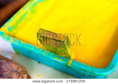Close up stamp and bright yellow dye for cloth