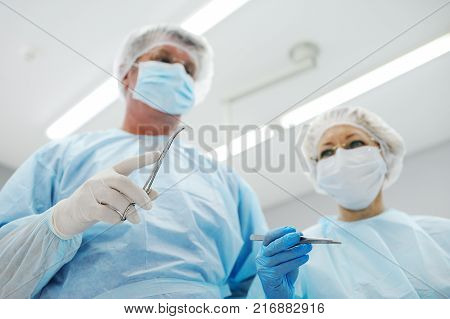 surgeons operate on a patient in the background Surgical Lamp