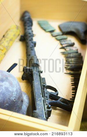The rusty raked helmet and machine-gun tape at box
