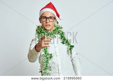 man in glasses and white shirt points with his hand forward, new year, corporate, holiday, light background.