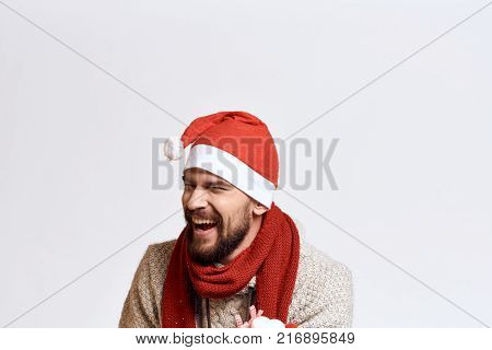 a man in a Christmas hat laughs, a light background, a free copy space, a Christmas, a new year.
