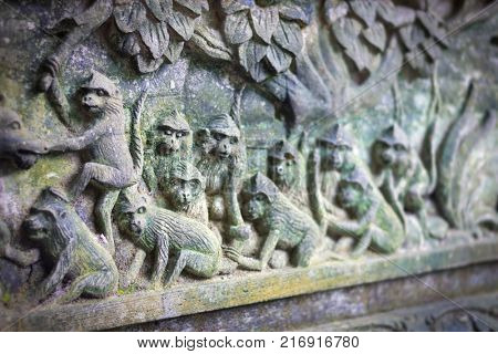 Fragment of bas-relief featuring  monkeys on  Padangtegal Great Temple of Death (Pura Dalem Agung Padangtegal) in the Sacred Monkey Forest of Padangtegal, Ubud, Bali, Indonesia