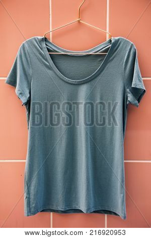 Gray tee hanging on the wall