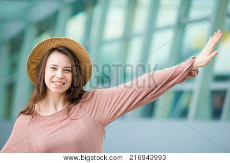 Young woman in international airport walking with her luggage.