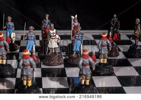 Chess pieces placed on the Board in random order on a black background.