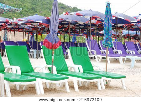 The green beach chairs in white sand
