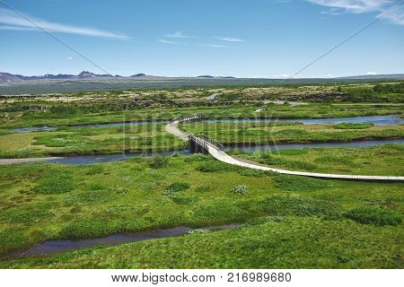 walkway in Thingvellir National Park, Iceland. Thingvellir National Park - famous area in Iceland right on the spot where the atlantic tectonic plates meets. UNESCO World Heritage Site