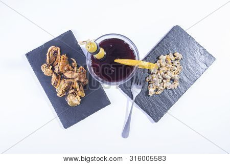 Refreshing Vermouth With A Slice Of Orange, And Mussels On A Black Slate Top View
