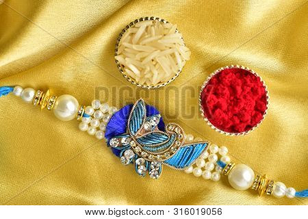 Rakhi With Roli Chawal On Golden Backgroud, Top View