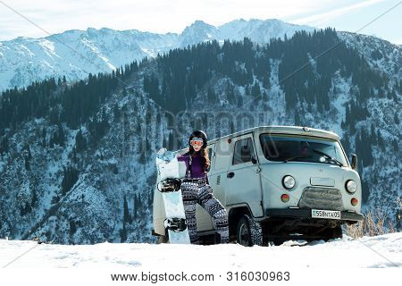 Almaty, Kazakhstan - January 10, 2019: Uaz 452 And Snowboard Burton Girl In Tian-shan Mountain On Fr