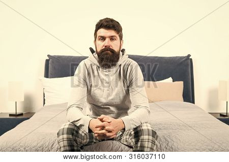 Tips For Waking Up Early. Man Bearded Hipster Sleepy Face Pajamas Waking Up Bedroom Interior. Daily 