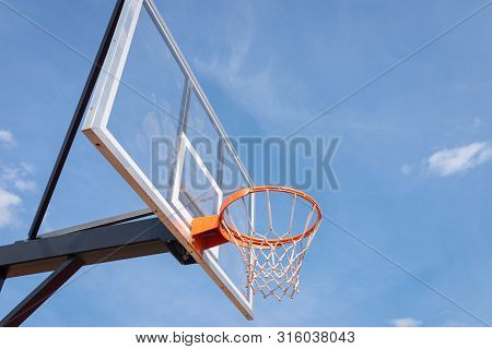 Basketball Board With Basket Hoop Against Blue Sky. Sport, Recreation.