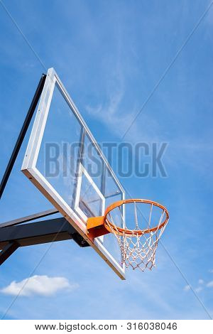 Basketball Board With Basket Hoop Against Blue Sky. Sport, Recreation.