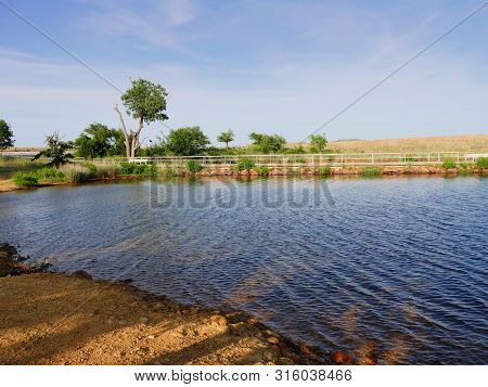 Side View Shot Of Lake Elmer Thomas With The Dock In The Background, Wichita Mountains, Oklahoma