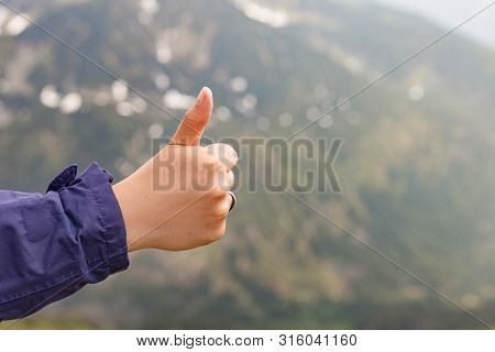 Happy Fimale Traveler Showing Thumb Up In Spring Mountains, Point Of View Shot