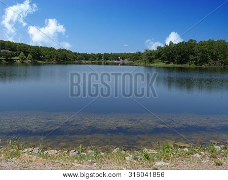 Scenic Wide Shot Of A Lake At Chickasaw National Recreation Area In Davis, Oklahoma