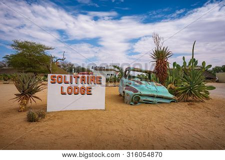 Solitaire, Namibia - March 29, 2019 : Welcome Sign At The Solitaire Lodge With A Car Wreck. Solitair
