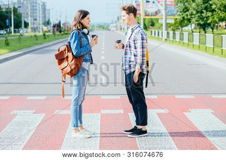 A Picture Of A Happy Young Couple Students Meeting Face To Face On A Walk On A Day Off. A Happy Frie