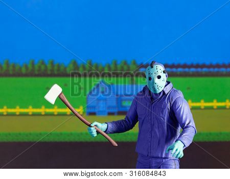 AUG 6 2019: recreation of a scene from the Nintendo NES 8-Bit Friday the 13th video game showing Jason Voorhees in day glow colors - Neca GameStop exclusive action figure