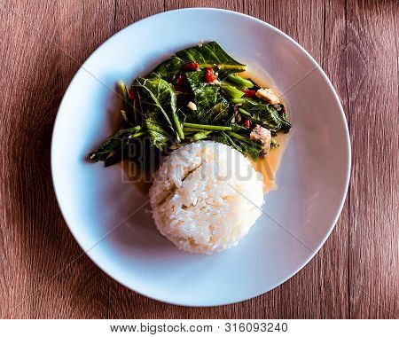 Stir-fried Kaled With Sun-dried Salted Fish With Rice On White Dish