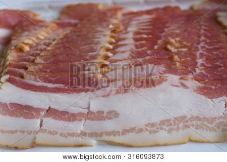 Raw Bacon Slices Nicely Aligned Close Up.