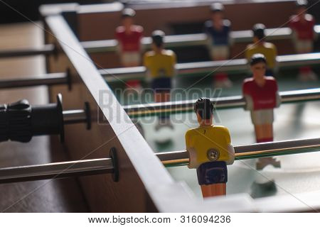 Table Football With Yellow And Red Kickers.