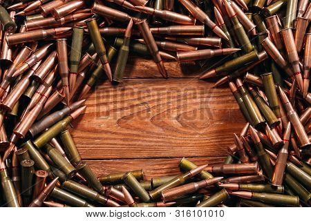 Different Ammo On Wooden Background. Weapon Concept