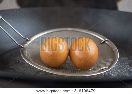 Taking Boiled Eggs Out Of Boiled Water. Close Up Macro Shooting