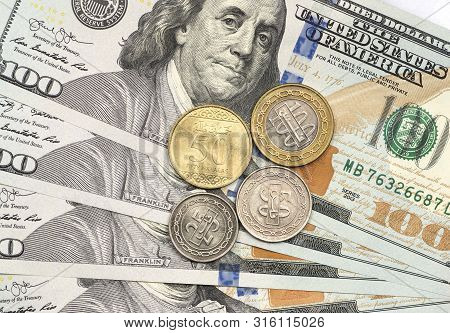 Saudi Riyal Coin On Top Of Dollar Bills For Financial And Investment Concepts