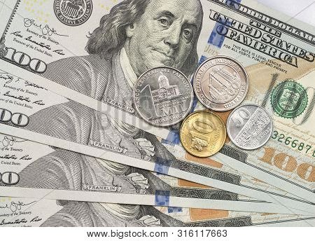 Paraguayan Guarani Coin On Top Of Dollar Bills For Financial And Investment Concepts