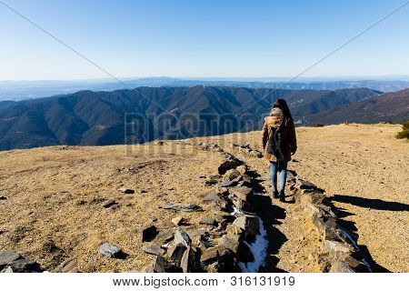 Beautiful Woman Hiking On Mountain Path During Winter Or Autumn In Catalonia (turo Del Home - Spain)