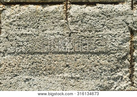 Close-up Of An Old Ferro Concrete Wall With Rusty Reinforcement Rods