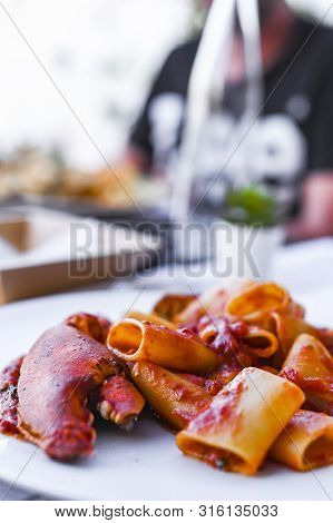 Pasta With Spiny Lobster And Tomato Sauce. Seafood Lunch At The Restaurant And A Glass Of White Wine